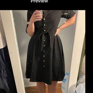 Black business dress with a collar and gold buttons